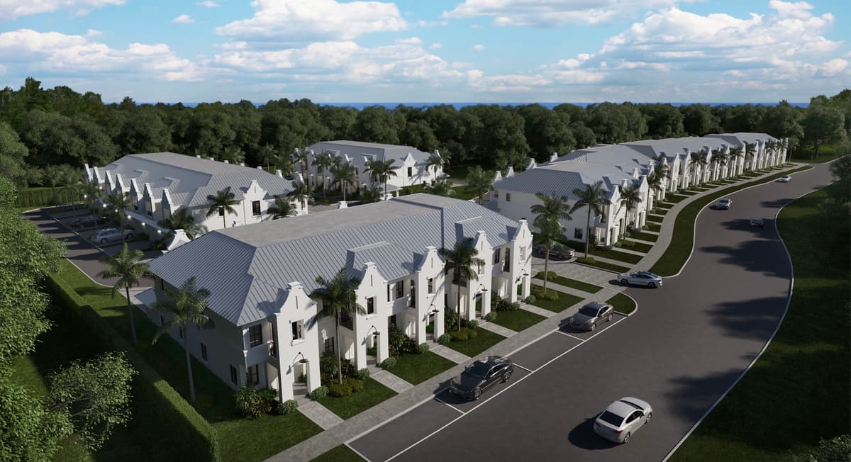Rendering of Gold in Hobe Sound: rows of white two-story townhouses with Dutch gables and standing-seam metal roofs along a curving palm-lined drive