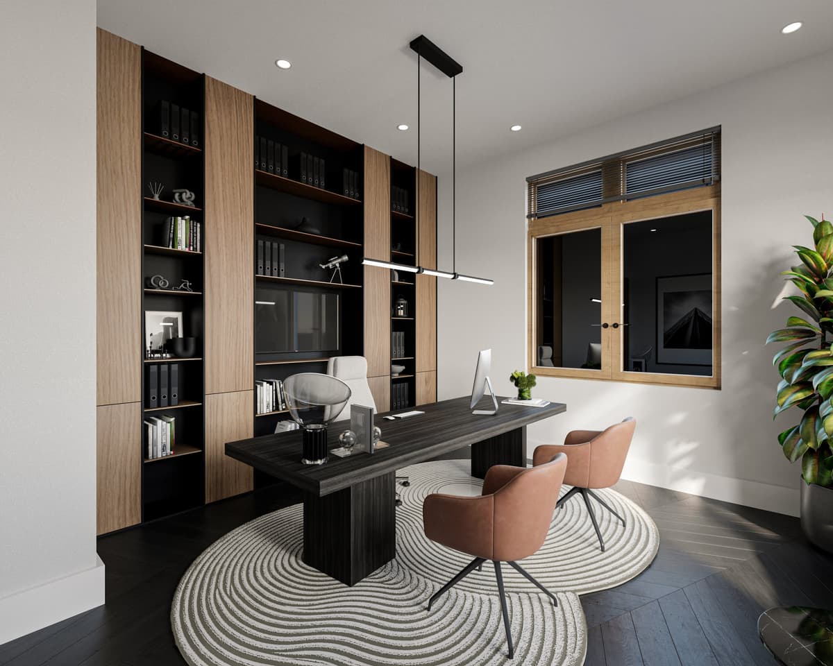 Office with black shelving, a black desk and two cognac chairs on a round rug