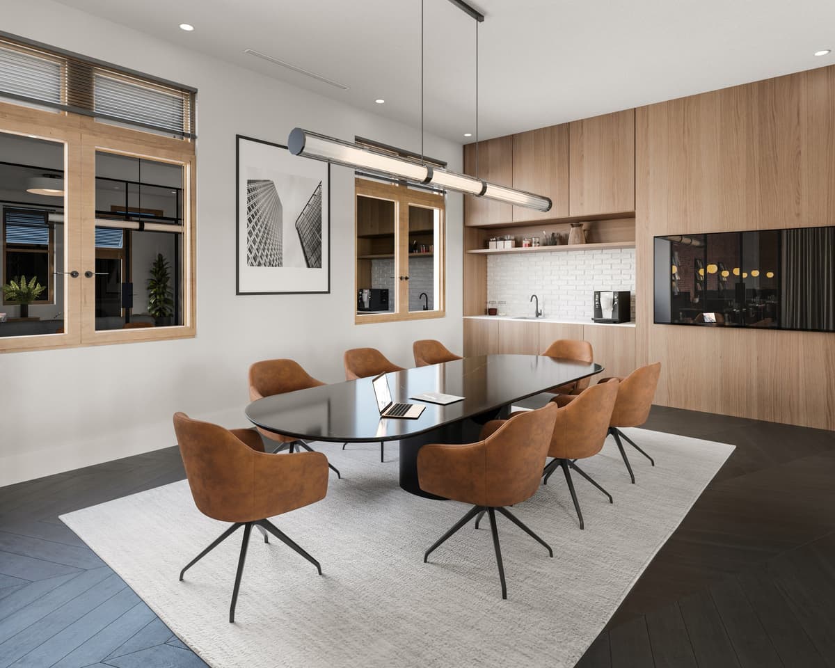 Meeting room with an oval black table, cognac swivel chairs and a kitchenette