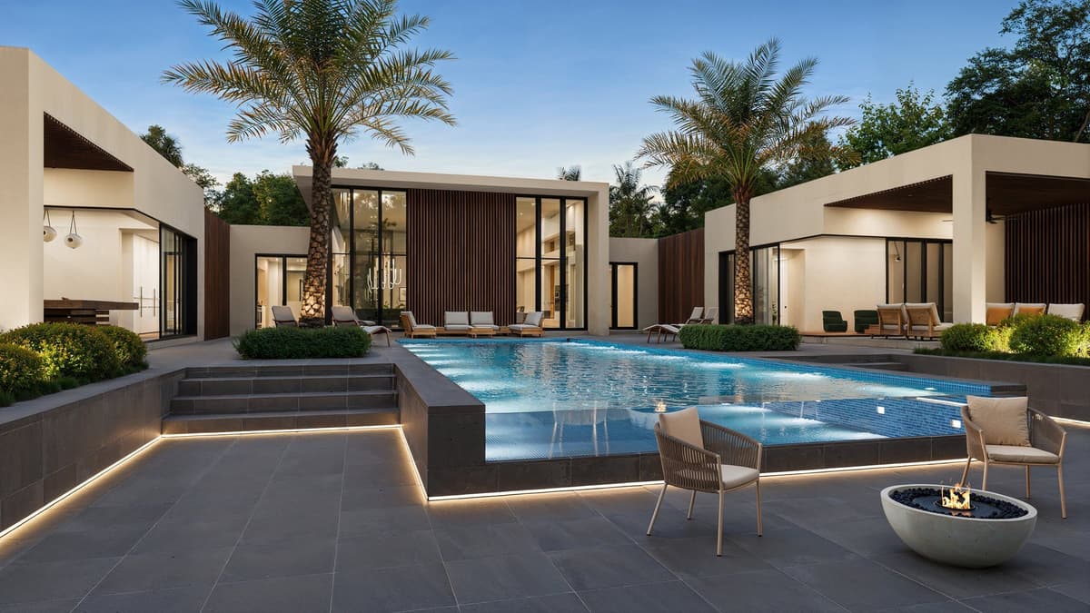 Rendering of Pennock Point at dusk: a lit infinity-edge pool between two modern pavilions
